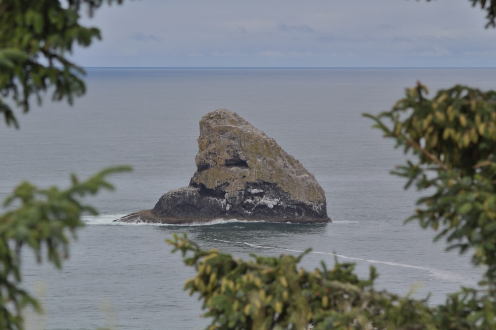 a large rock sticking out of the ocean