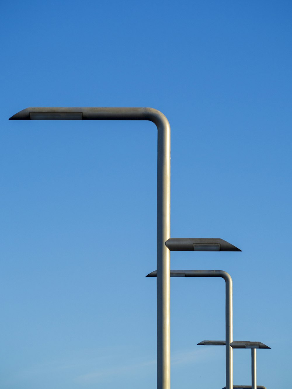 a group of metal poles against a blue sky
