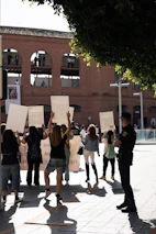 a group of people holding up signs in the air