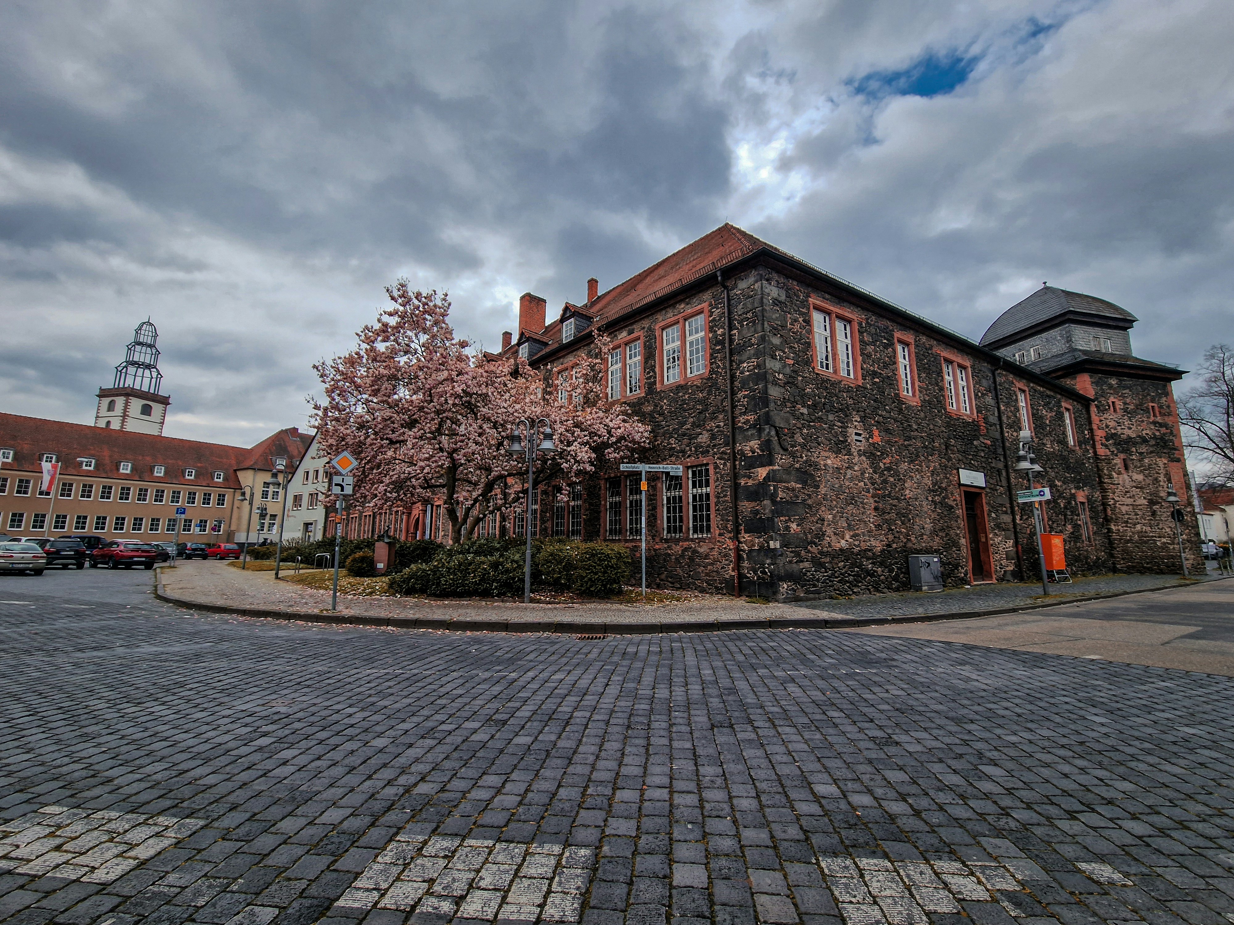 a large brick building with a clock tower in the background