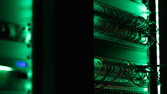 a rack of electronic equipment in a dark room