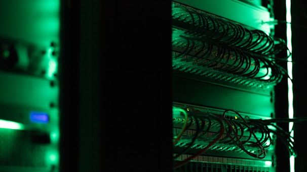 a rack of electronic equipment in a dark room
