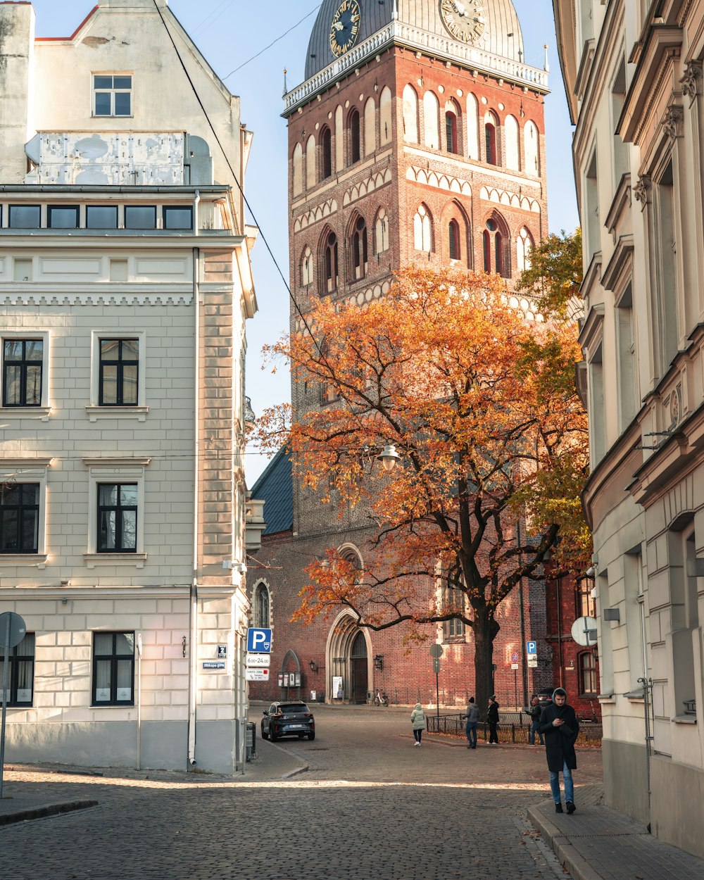 a tall clock tower towering over a city street