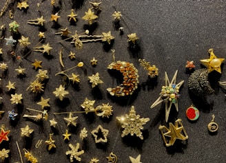 A variety of small gift items including pins, keychains, and badges arranged on a rustic wooden surface.