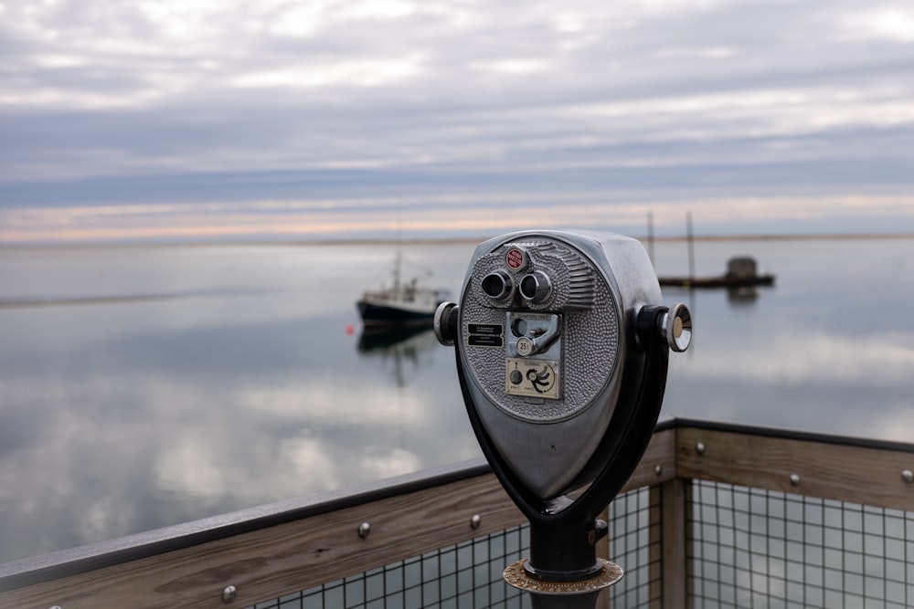 a coin operated parking meter overlooking a body of water