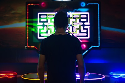 a man standing in front of a neon display