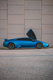 a blue sports car with its hood open