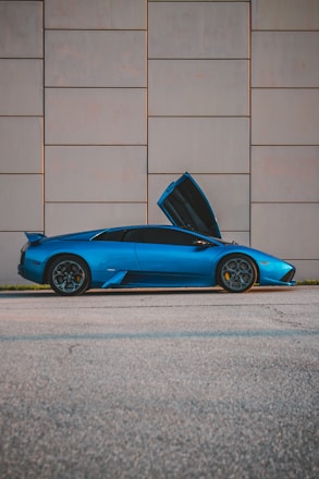 a blue sports car with its hood open