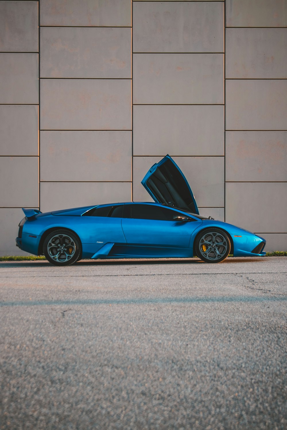 a blue sports car with its hood open