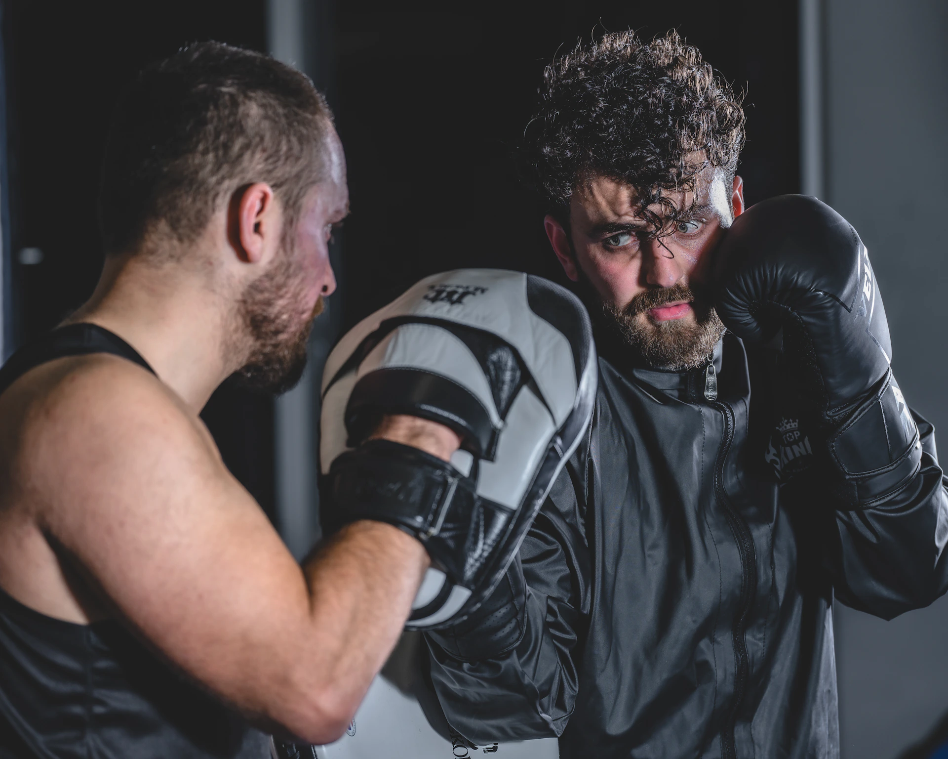 a man with a beard wearing boxing gloves