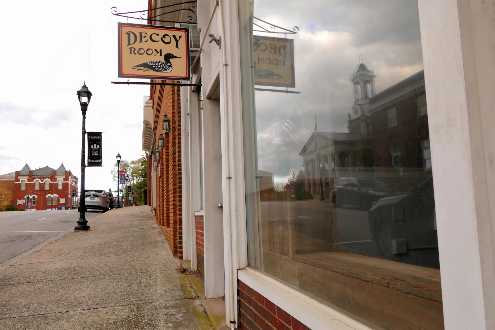 Historic downtown storefronts and clock tower along a walkable plaza