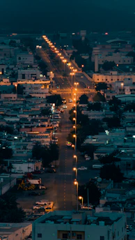 Solar street lights illuminating a busy municipal road at dusk with clear visibility.