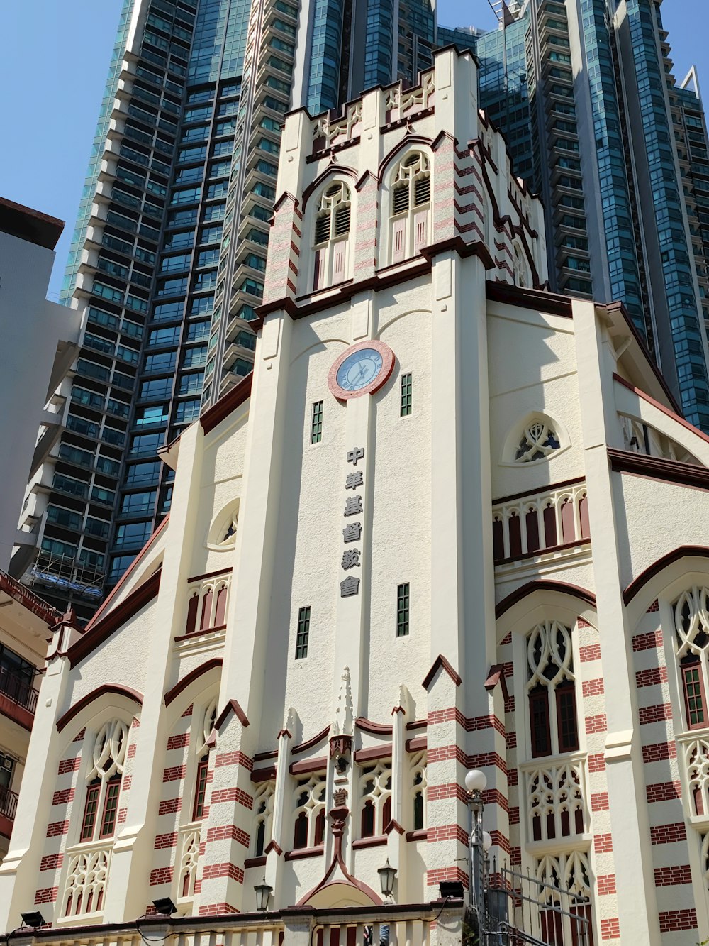 a tall white building with a clock on it's side