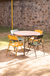 a table and chairs sitting in the dirt