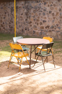 a table and chairs sitting in the dirt