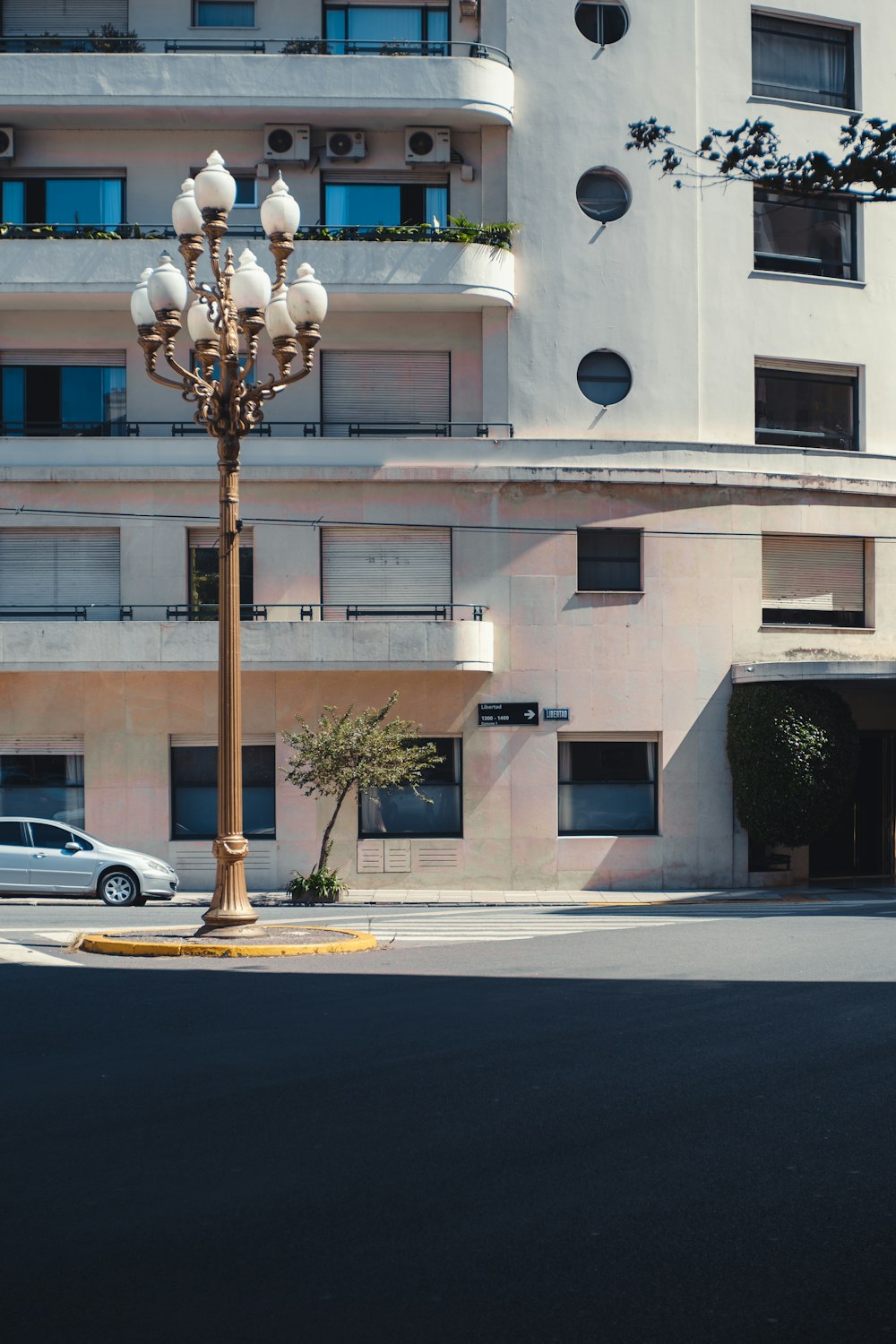 a street light sitting in front of a tall building