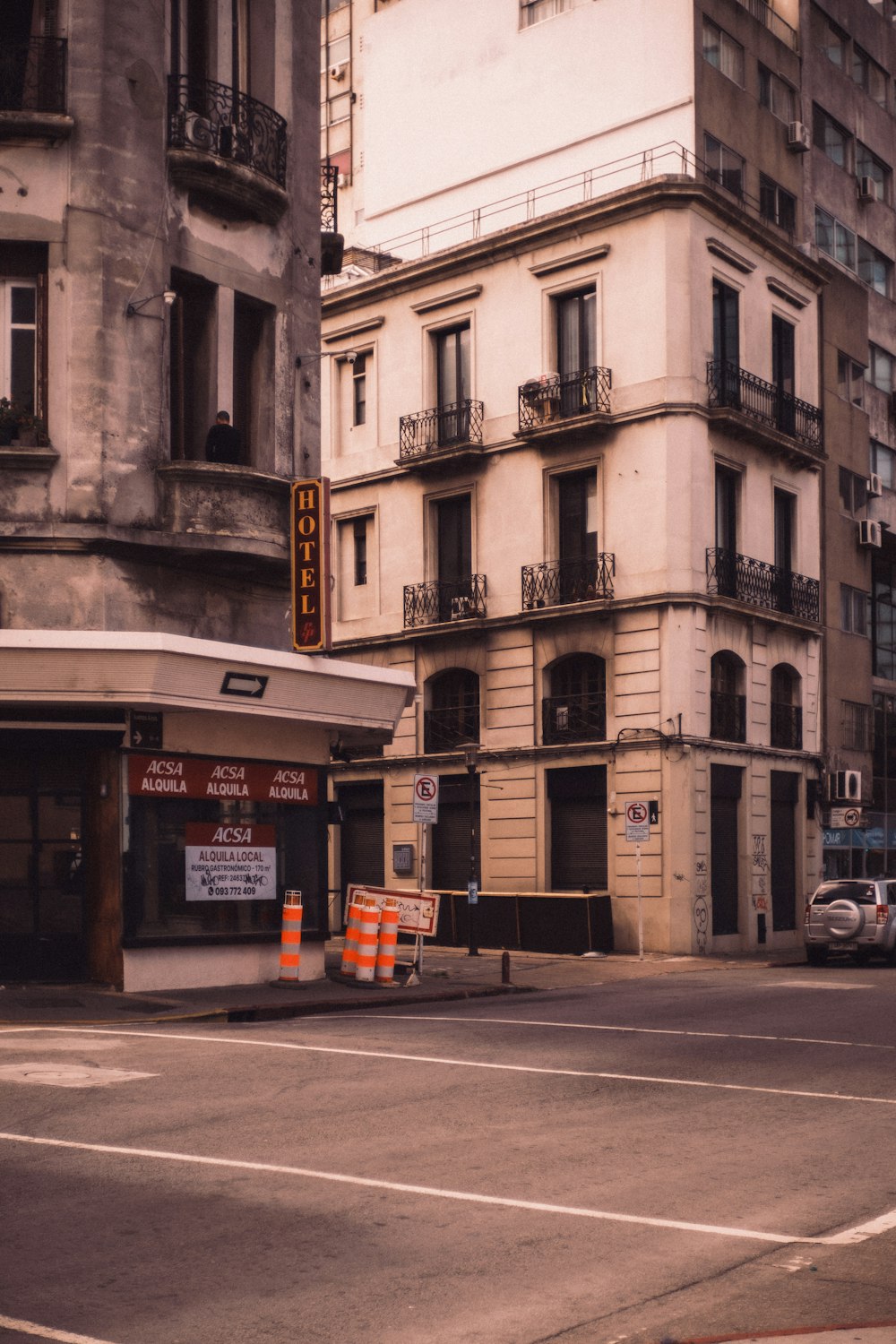 a street corner with a building and traffic cones