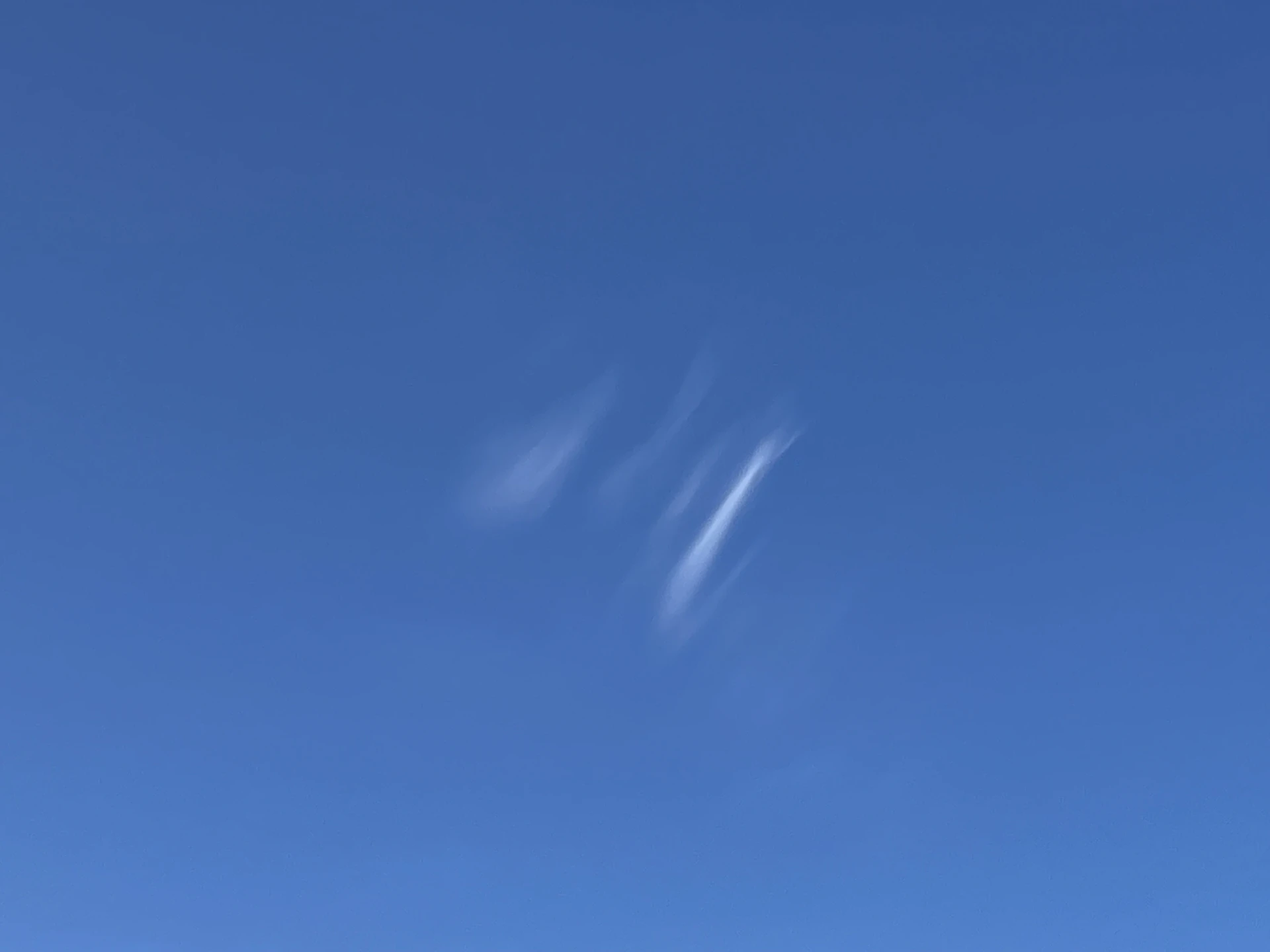 a clear blue sky with some clouds in it