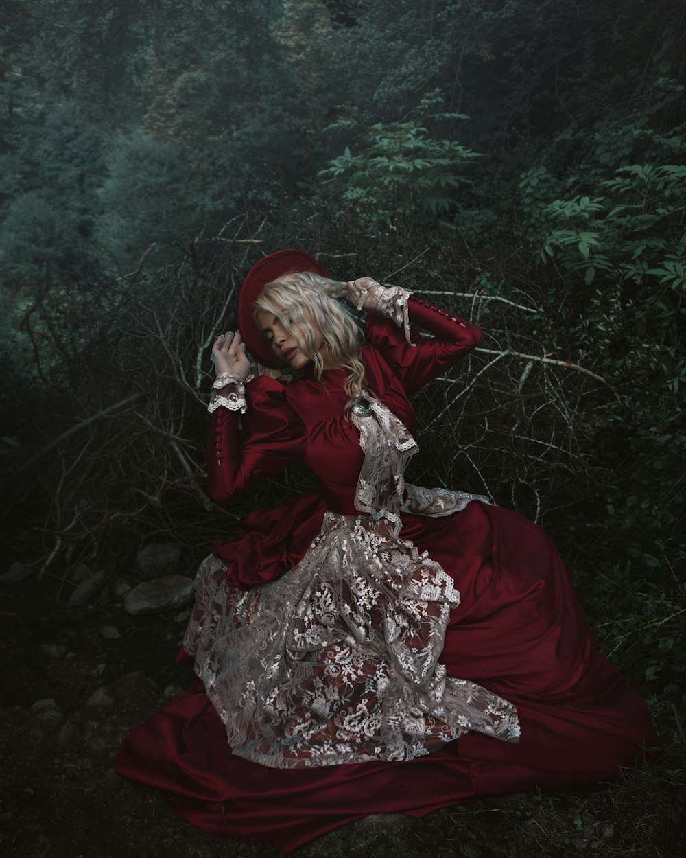a woman in a red dress in a forest