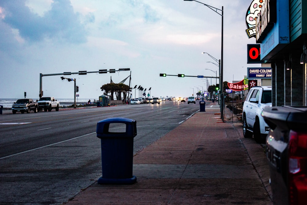 a city street with cars parked on the side of the road