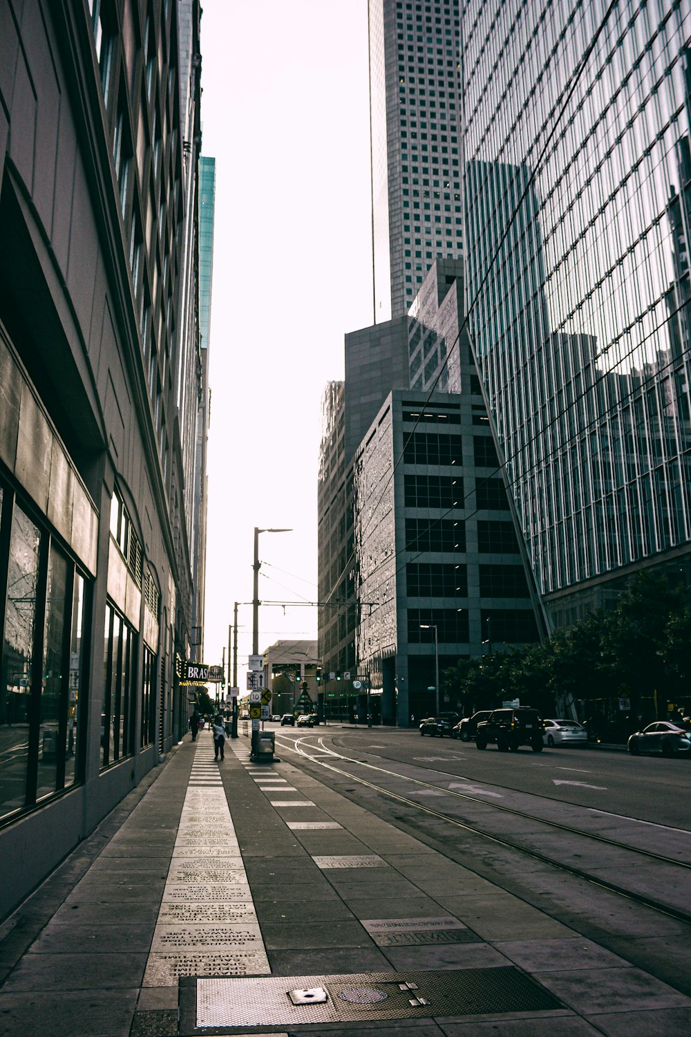 a person walking down a city street next to tall buildings