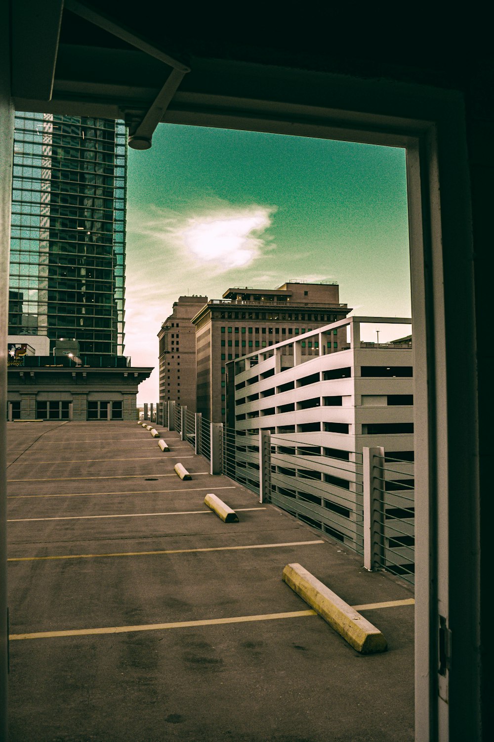 an empty parking lot in front of tall buildings