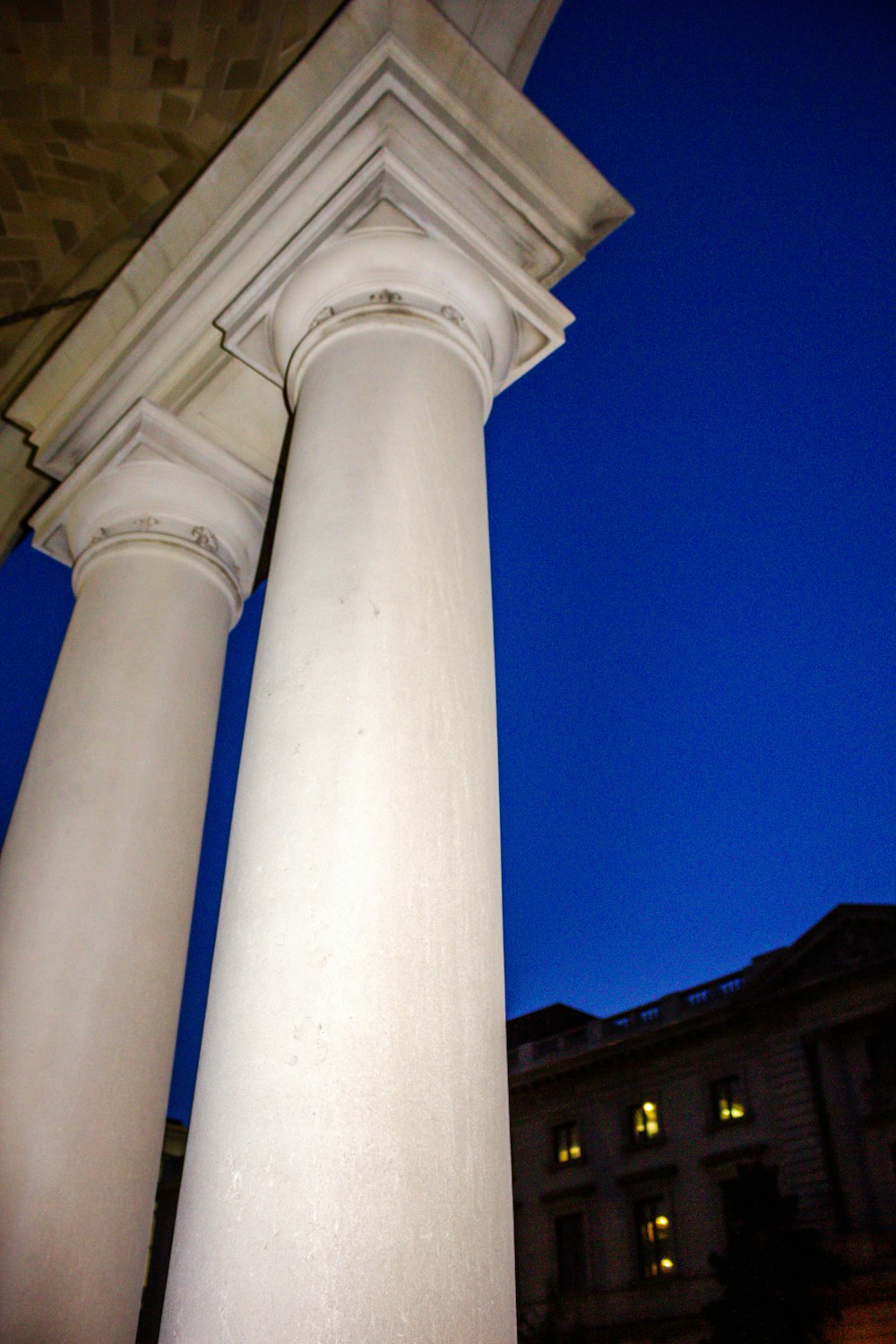 a tall white pillar sitting next to a building