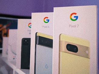 A sleek display of various Google Pixel smartphones arranged on a wooden table.