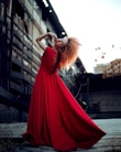 A model showcasing a fashionable dress in an urban setting.