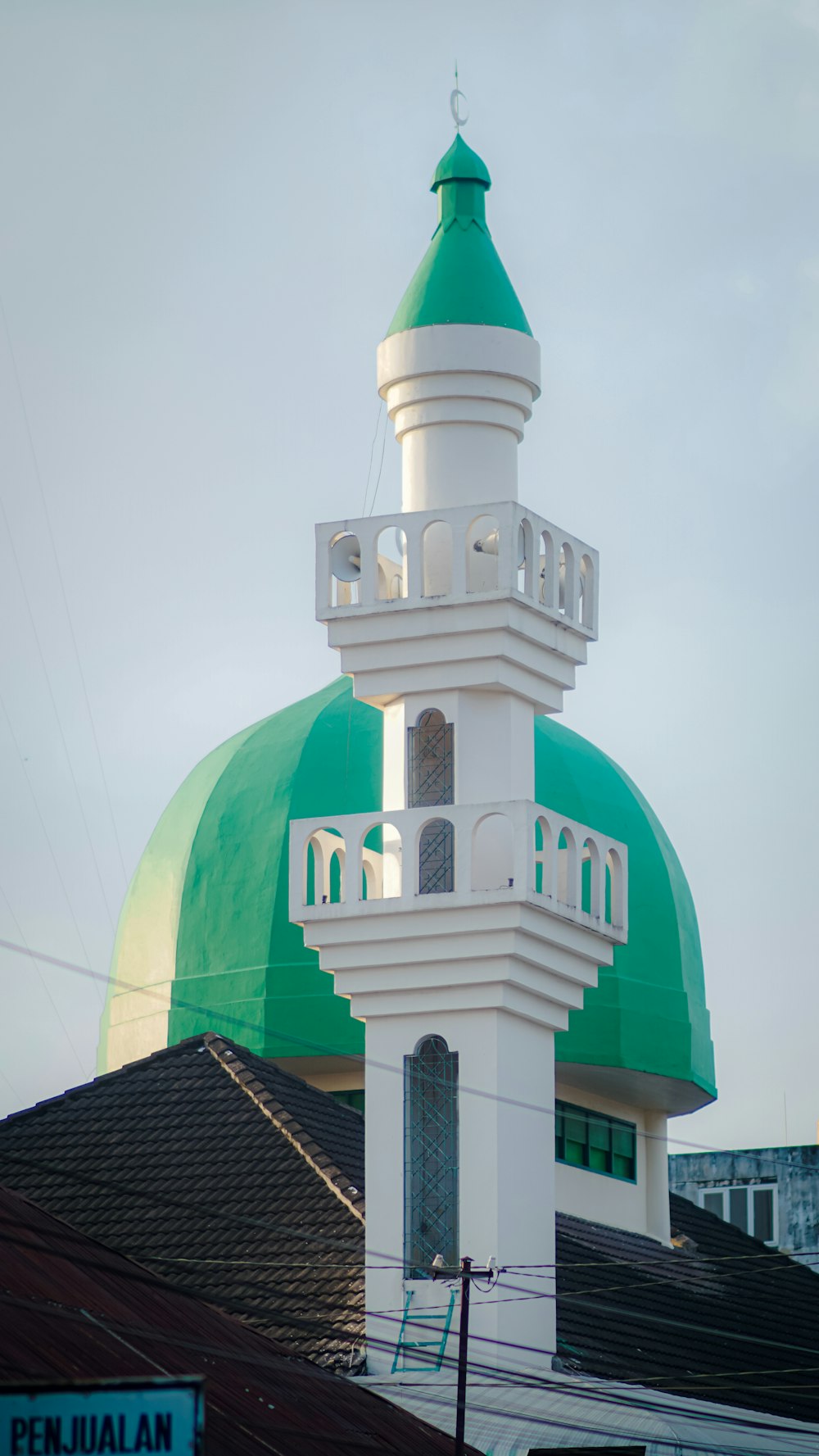 a large white and green building with a green dome