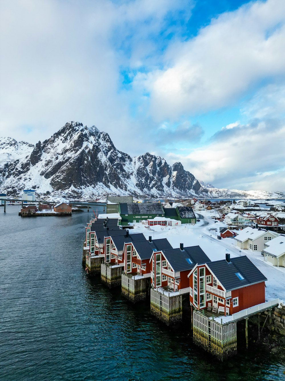 a group of houses sitting on top of a body of water