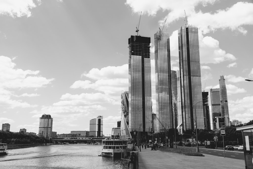 a black and white photo of a river and some buildings