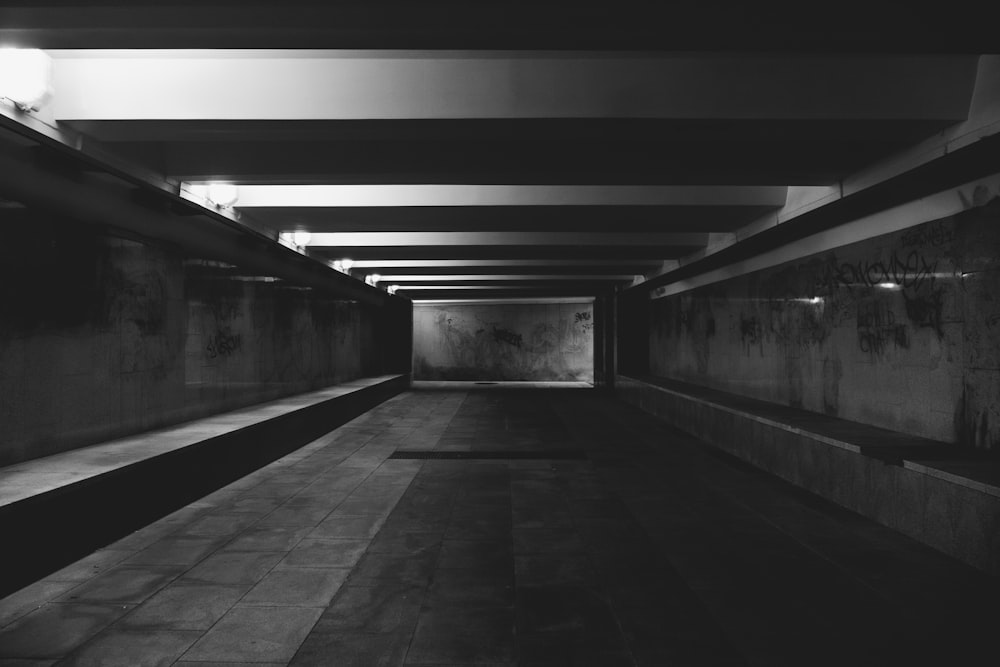 a black and white photo of a long hallway