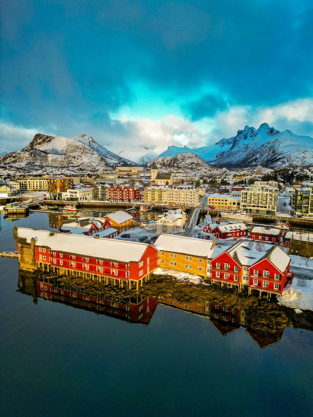 a red building sitting on top of a body of water