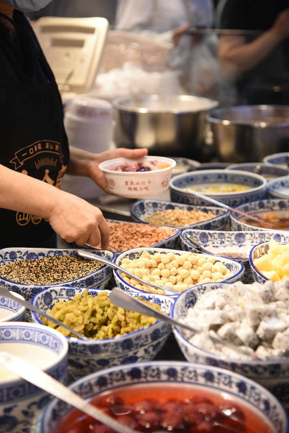 a person in a kitchen preparing food in bowls