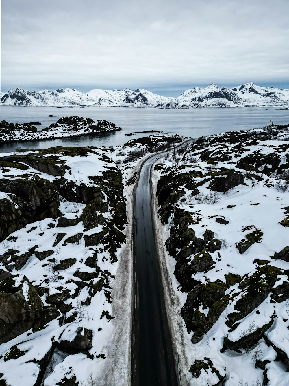 an aerial view of a road surrounded by snow