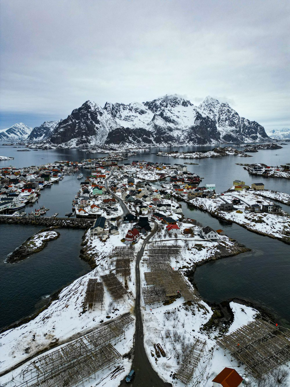 an aerial view of a small town in the middle of a body of water