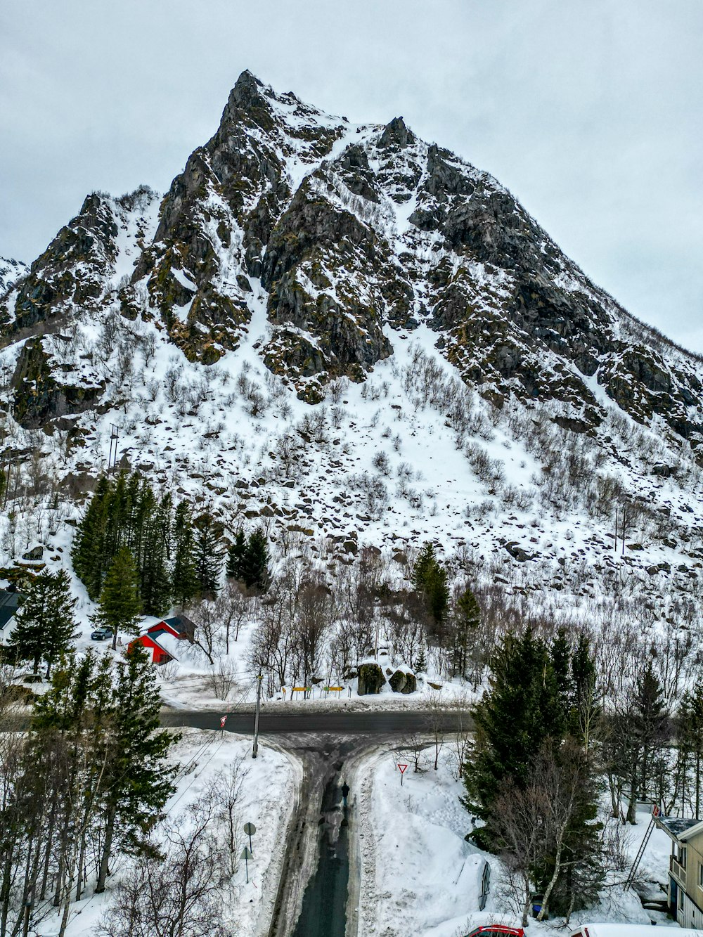 a snow covered mountain with a road going through it