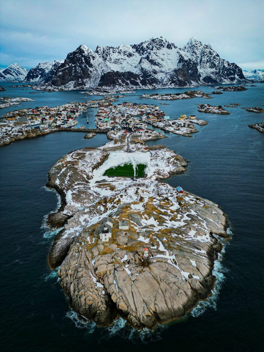 an aerial view of a small island in the middle of a body of water