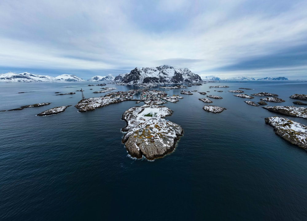 a large body of water surrounded by snow covered mountains