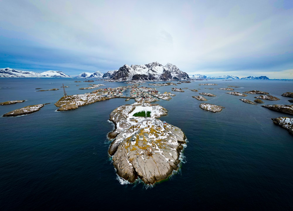 a large body of water surrounded by snow covered mountains