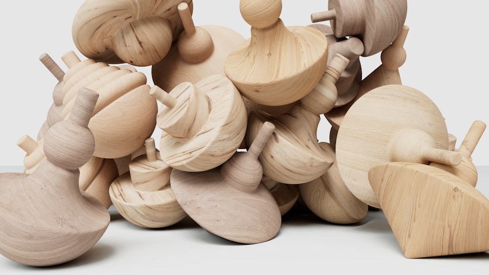 a pile of wooden toys sitting on top of a table