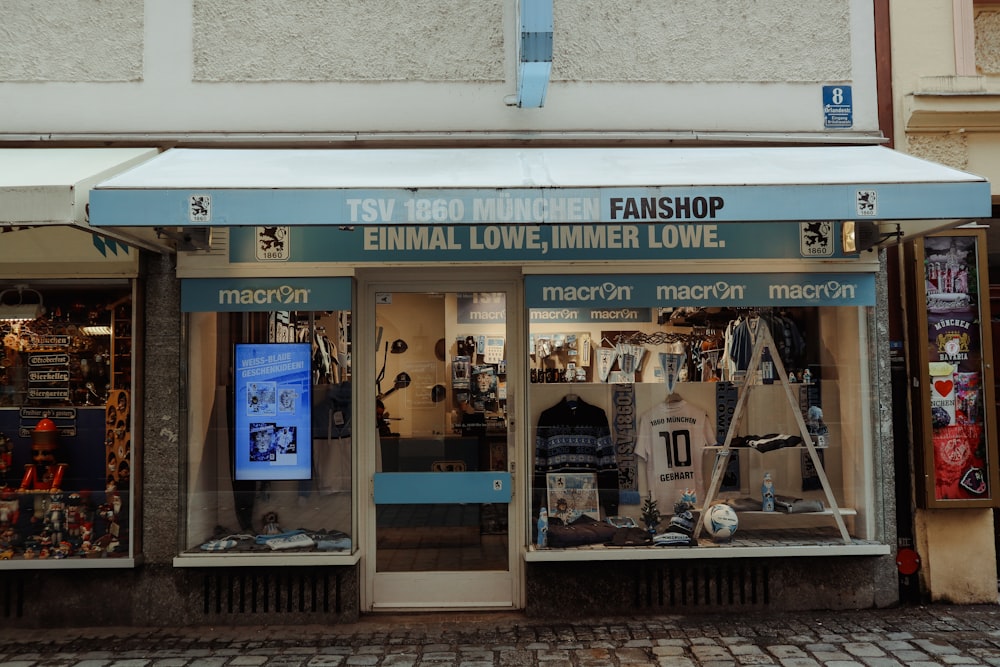 a store front with a white awning and a blue and white awning