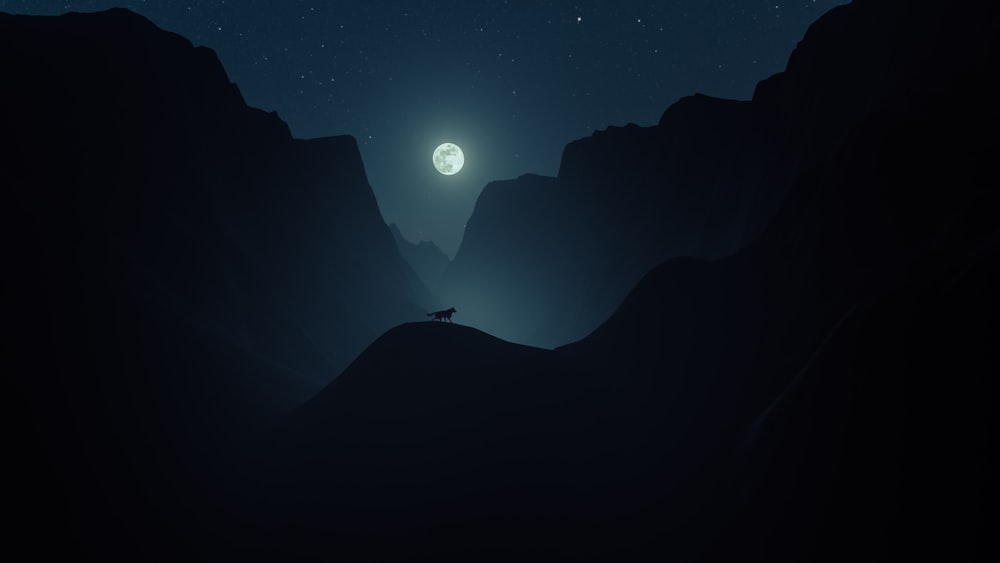 a person standing on top of a mountain under a full moon