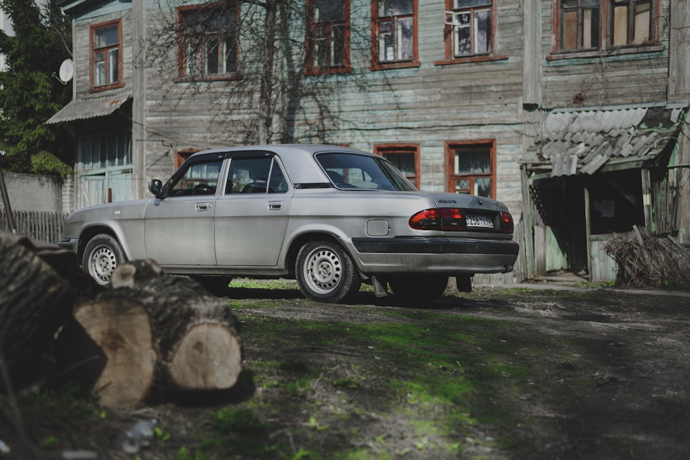 a silver car parked in front of a building