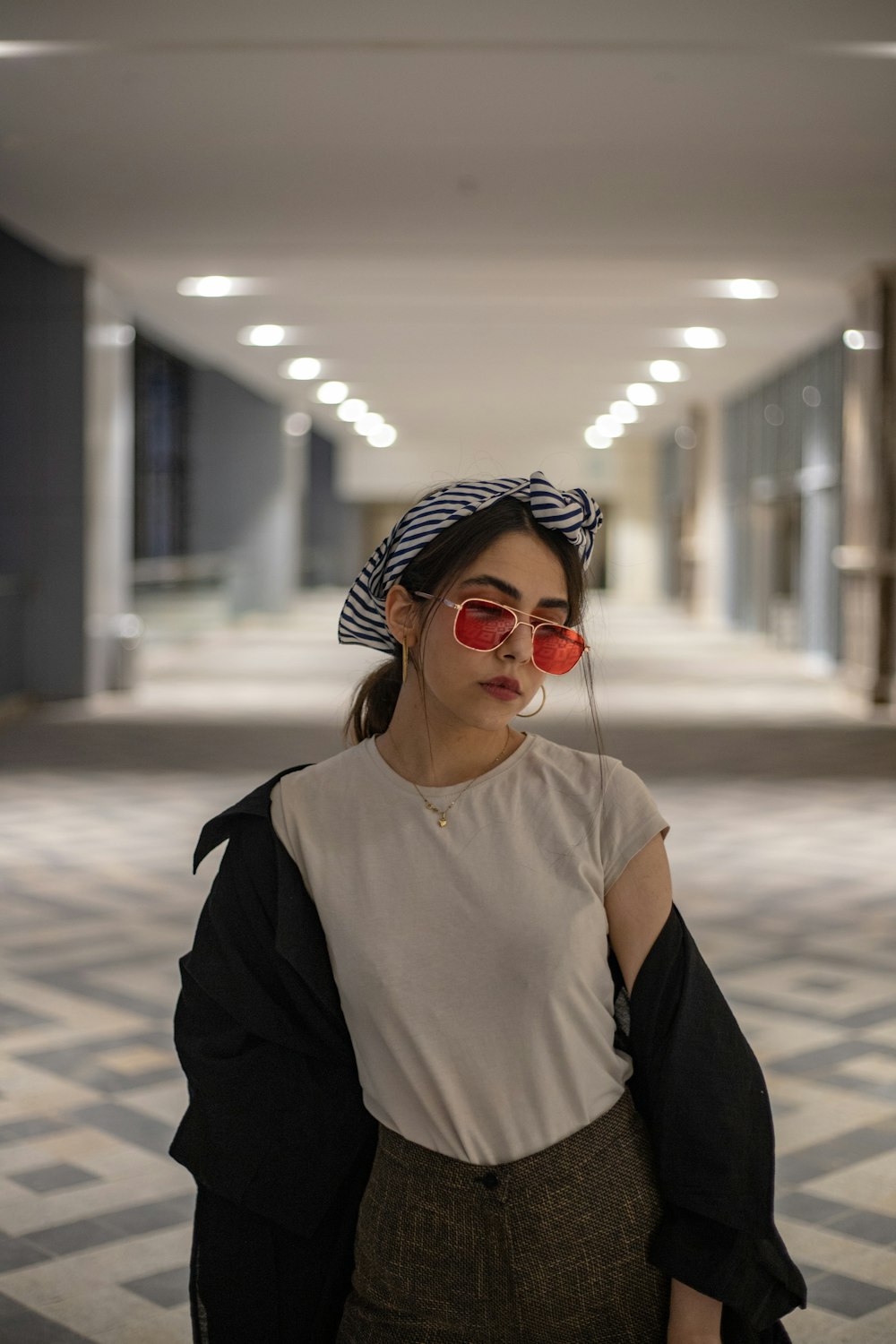 a woman wearing red sunglasses and a hat