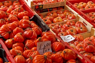 a display in a grocery store filled with lots of tomatoes