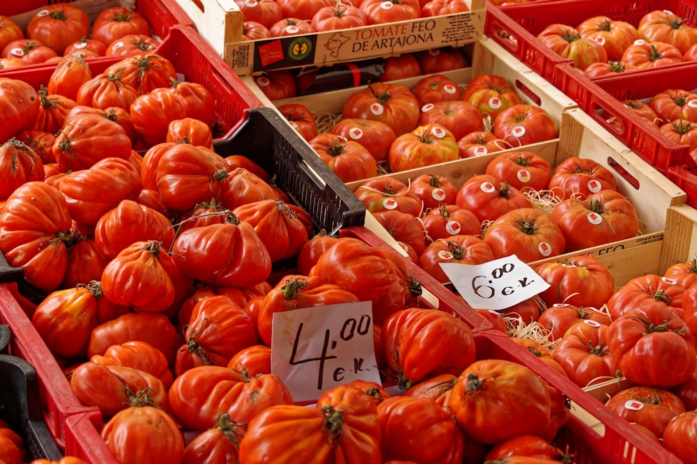 a display in a grocery store filled with lots of tomatoes