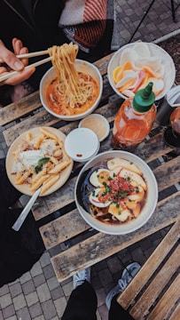 a wooden table topped with plates of food