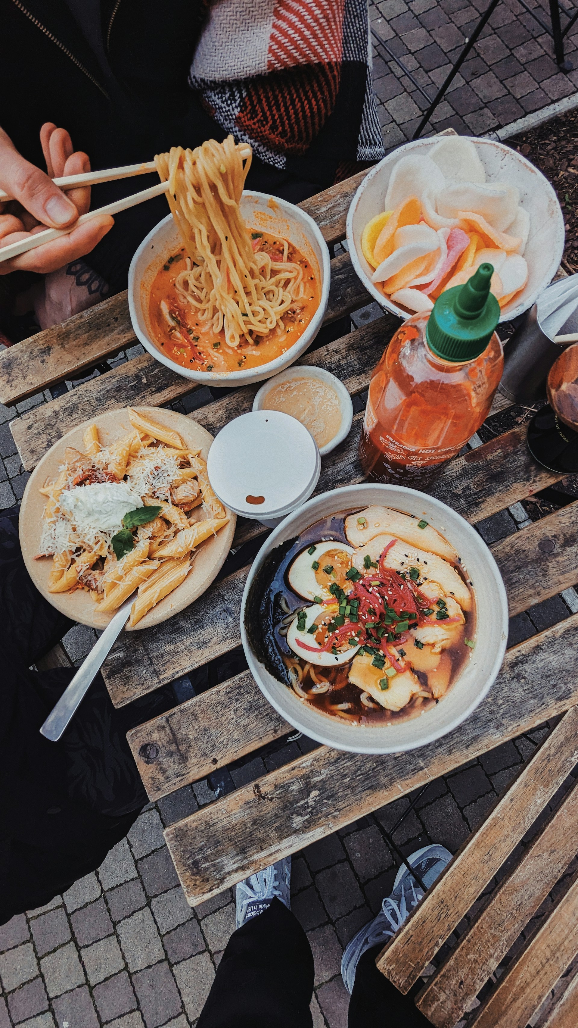 a wooden table topped with plates of food